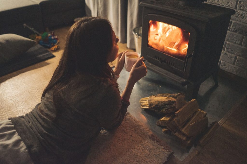 girl infront of a coal fire